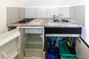 a small kitchen with a sink and a sink at Apartments & Rooms Strčić Krk in Krk