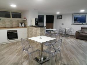 a living room with tables and chairs and a couch at Stella marina in Palinuro