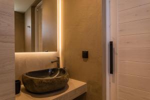 a bathroom with a large bowl sink on a counter at Lighthouse Apartments in Stoupa
