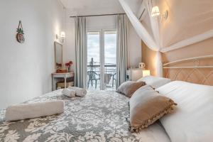a bedroom with a bed with two pillows on it at Eros Beach Hotel in Benitses
