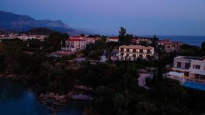 an aerial view of a resort with a river and buildings at Lighthouse Apartments in Stoupa