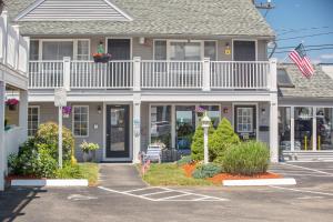 a house with a balcony on top of it at Nantasket Beach Hotel in Hull