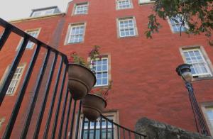 un edificio de ladrillo rojo con ventanas y luz de la calle en 2 Chessels Court, Flat 3, en Edimburgo