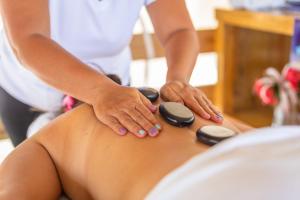 a woman getting a massage from a therapist at Portofino Beach Resort-An Authentic Island Escape! in San Pedro