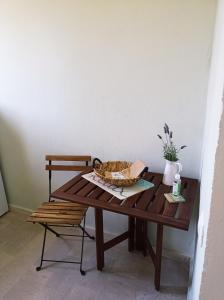 a cat sitting in a bowl on a wooden table at Alcyon days in Agios Georgios +32 photos