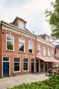a brick building with a red brick patio at Cozy Typical Dutch Apartments in Groningen