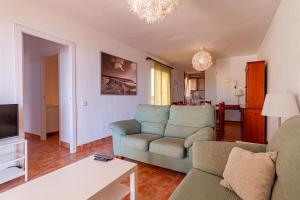a living room with a couch and a tv at Arpon 8C in La Manga del Mar Menor