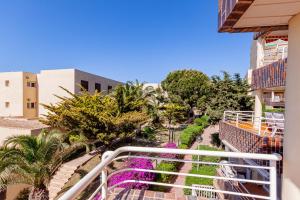 a balcony of a building with purple flowers and trees at Inmovecos Arpon 8C in La Manga del Mar Menor