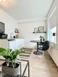 a kitchen and dining room with a table and chair at Day Dream R1 Townhall Studio in Akureyri