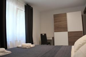 a bedroom with a bed with two towels on it at Apartman Boki in Pag