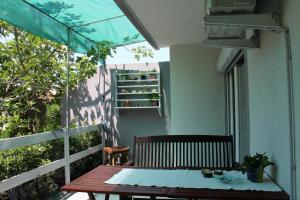 a table on the balcony of a house at Apartman Boki in Pag