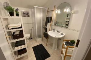 a bathroom with a sink and a toilet and a mirror at BLUE LAGOON - condomínio fechado LAGOA DE ÓBIDOS in Foz do Arelho +40 photos