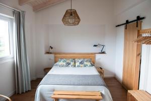 a bedroom with a bed and a pendant light at La Casita de Melón in Suances