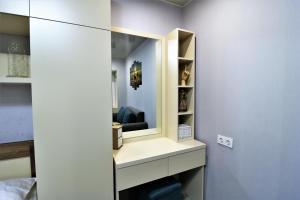 a dressing room with a mirror on a wall at Apartment On Gudiashvili in Tbilisi City +25 photos