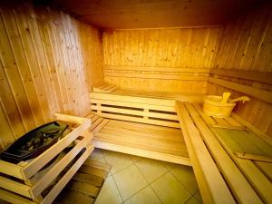 a wooden sauna with a hot tub and a tub at Villa 250m2 avec PISCINE chauffée & SPA & kota-grill & sauna in Saint Die