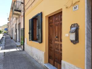 a yellow building with a door and a street at Stefano apartment 2km Tropea boat cruise included in Parghelia