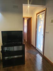 a living room with a flat screen tv on a table at Casa da estrela canopus in Cabeço Chão