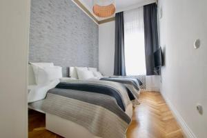 a bedroom with two beds in a room at Premium Apartment by Hi5-Vaci str. 3 bedroom (218) in Budapest
