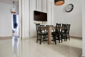 a dining room with a table and chairs and a clock at Premium Apartment by Hi5-Vaci str. 3 bedroom (218) in Budapest
