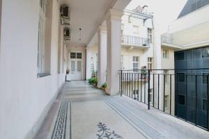 a hallway of a white building with a balcony at Premium Apartment by Hi5-Vaci str. 3 bedroom (218) in Budapest