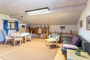 a living room with a couch and a table at Ferienwohnung Heinrich in Gmund am Tegernsee