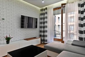 Telewizja i/lub zestaw kina domowego w obiekcie Apartamenty Prestige Browar Lubicz Stare Miasto