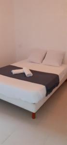 a bed with white sheets and pillows on it at Casa Prunelli 2 in Omessa