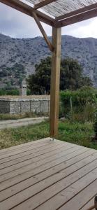 a wooden deck with a view of a mountain at Casa Prunelli 2 in Omessa +3 photos