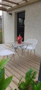 a white table and two chairs on a patio at Casa Prunelli 2 in Omessa