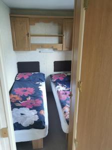 a small room with two beds in a trailer at Lochlands caravan park X(6) in Forfar