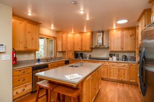 a large kitchen with wooden cabinets and a counter top at Moonrise Lodge - A Large Vacation Home in Mariposa in Mariposa