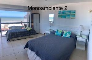 a bedroom with two beds and a view of the ocean at Terraza Marina in Ostende +3 photos