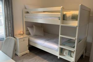 a room with two bunk beds and a desk at Grade II listed, town house in Monmouth