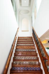 a staircase in a building with wooden railings at Hotel Boutique Plaza Doradas in San José del Cabo +29 photos