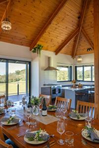a dining room with a table and a kitchen at Old Coach Road Estate in Hindmarsh Valley