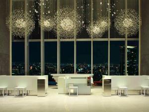 a room with tables and chairs and a large window at Osaka Marriott Miyako Hotel in Osaka
