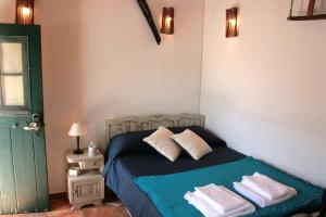 a bedroom with a bed with towels on it at Little Suite in Comporta