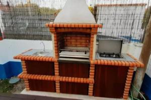 a model of a barbecue with a laptop on it at Little Suite in Comporta