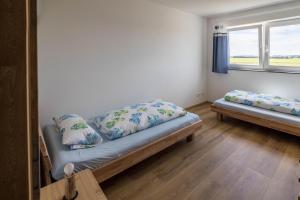 a room with a bed and two pillows on it at Ferienwohnung Häfele 2 in Bad Wurzach