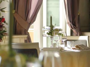 a table with wine glasses and a candle on it at GH Palazzo Suite & SPA in Livorno