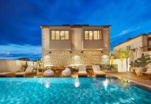 een villa met een zwembad en een huis bij Kaipo Alaçatı Adult Only in Alacati