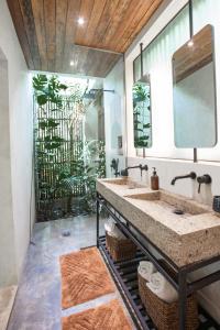 a bathroom with a sink and a large mirror at Surfing Temple Hotel Boutique in General Luna