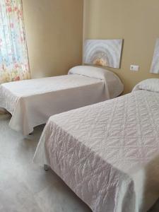 Posteľ alebo postele v izbe v ubytovaní Apartamento Nao Victoria