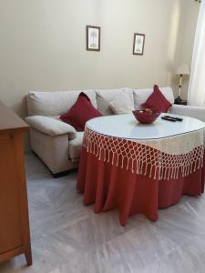 a living room with a table in front of a couch at Apartamento Nao Victoria in Sanlúcar de Barrameda