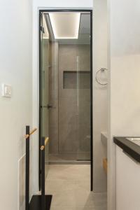 a glass door leading to a shower in a bathroom at Agora Suites in Chania