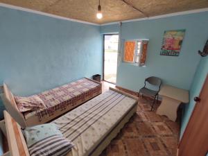a bedroom with two bunk beds and a desk at Отдых в Капшагае! in Kapchagay