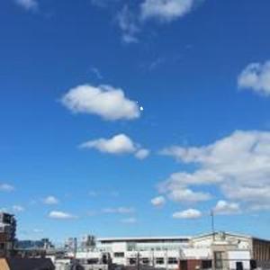 a plane flying high in the sky over a city at Tokyo Guest House 2020 in Tokyo
