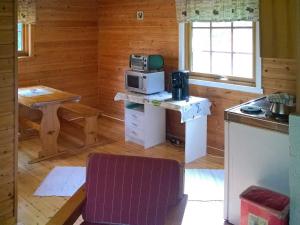 a kitchen with a microwave on a table in a room at Two-Bedroom Holiday home in Engavågen 1 in Åmnes