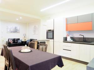 a kitchen and a dining room with a table and a couch at B&b La Rocca in Spoleto