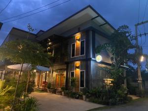 a house with a lit up facade at night at Nan Arena Place in Nan